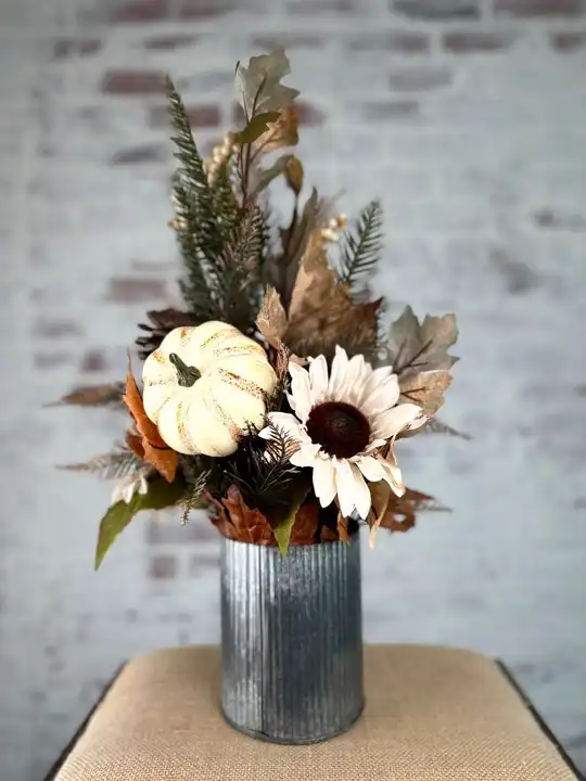 White pumpkin, sunflower and fall foliage arrangement in a galvanized vase